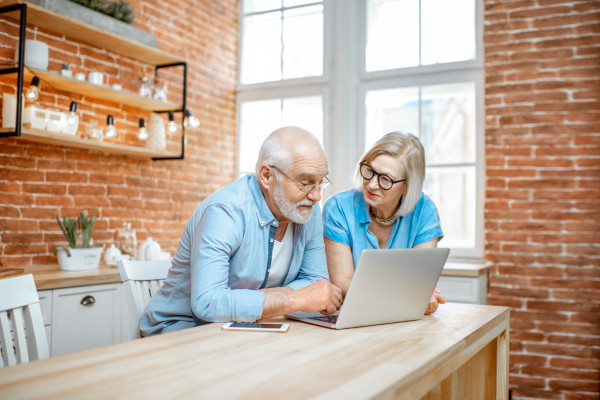 senior couple looking at laptop